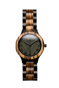 A wristwatch with a round wooden case and matching wood-and-black link bracelet, featuring a dark olive dial with black Roman numerals and hands, photographed on a brown textured surface